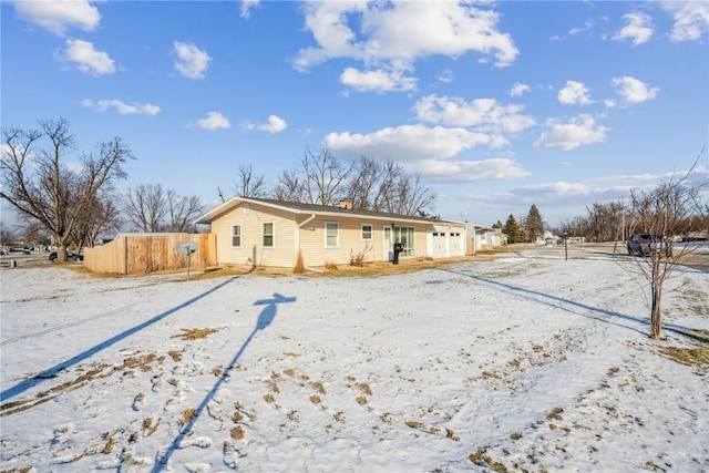 view of snow covered rear of property