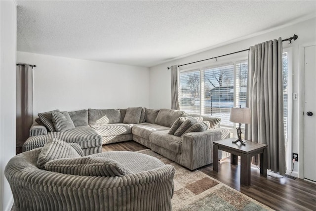 living room with hardwood / wood-style flooring and a textured ceiling