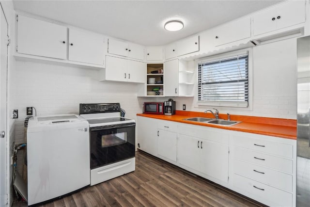 kitchen featuring electric range, washer / dryer, white cabinetry, and sink