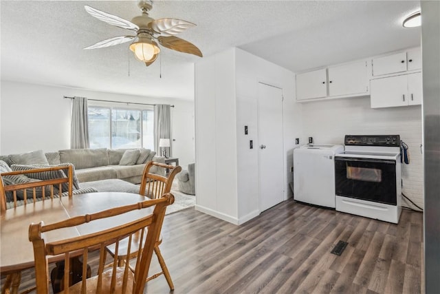 kitchen featuring white cabinets, dark hardwood / wood-style floors, ceiling fan, white range with electric stovetop, and washer / dryer