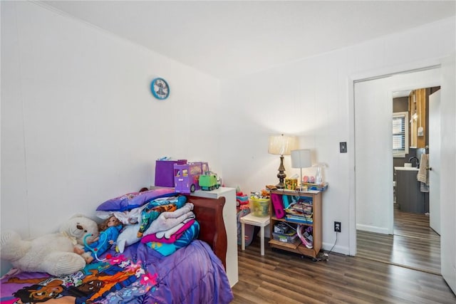 bedroom with dark hardwood / wood-style floors