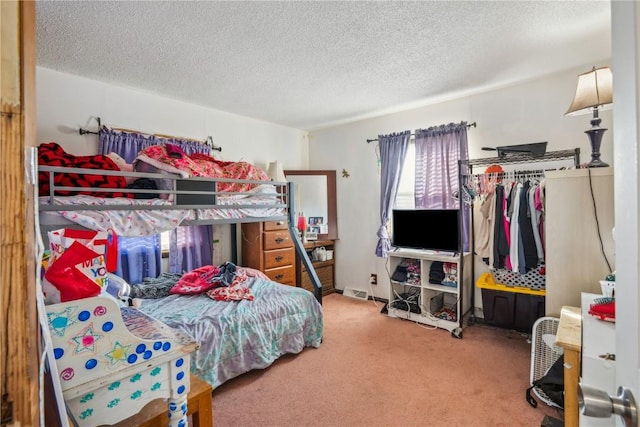 carpeted bedroom featuring a textured ceiling