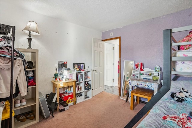 bedroom with carpet flooring and a textured ceiling