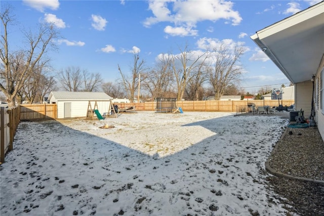 view of yard featuring a storage shed and central AC