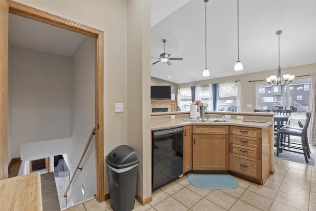 kitchen featuring lofted ceiling, ceiling fan with notable chandelier, sink, hanging light fixtures, and black dishwasher