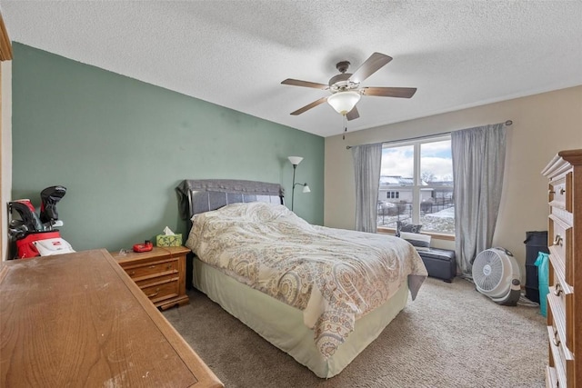 bedroom featuring ceiling fan, carpet, and a textured ceiling