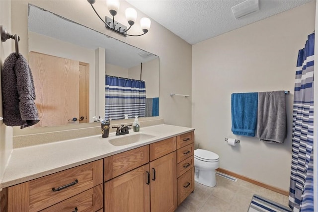 bathroom featuring vanity, a textured ceiling, and toilet