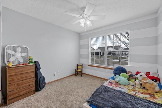 bedroom with a textured ceiling, light colored carpet, and ceiling fan