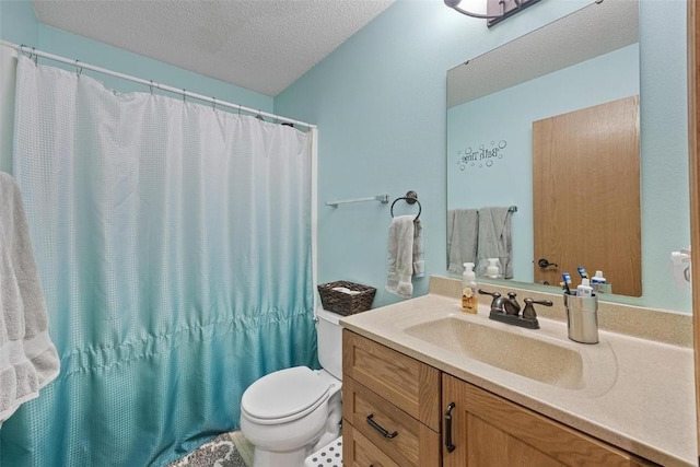 bathroom featuring a shower with curtain, vanity, toilet, and a textured ceiling