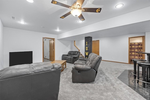 carpeted living room with ceiling fan