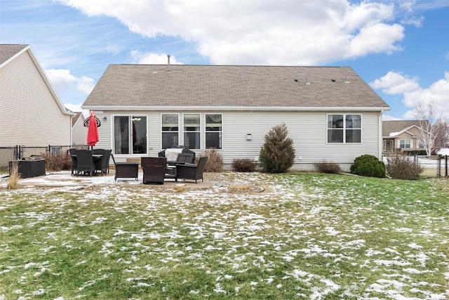 snow covered back of property with central AC unit, a patio area, and a lawn