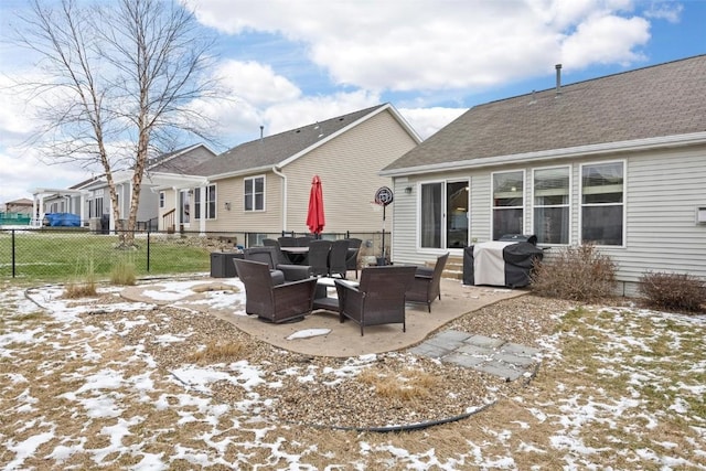 snow covered property with a patio