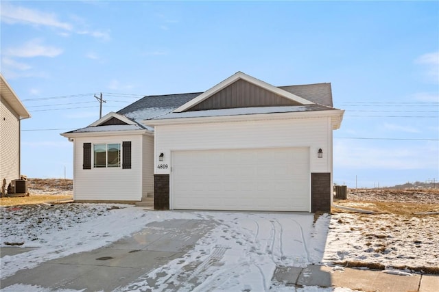 view of front of home featuring cooling unit and a garage