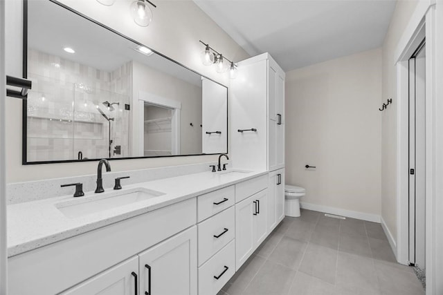 bathroom with tile patterned floors, a shower with door, vanity, and toilet