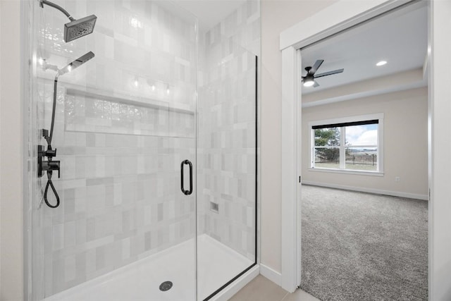 bathroom with ceiling fan and an enclosed shower