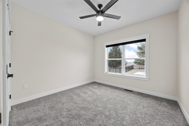 spare room featuring carpet floors and ceiling fan