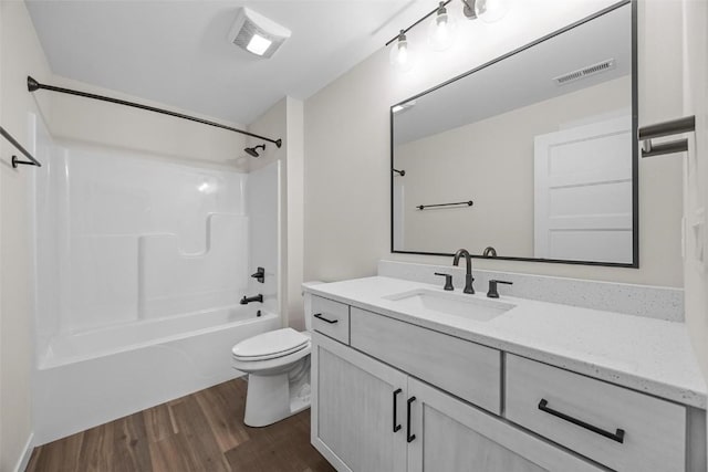 full bathroom with bathtub / shower combination, wood-type flooring, vanity, and toilet