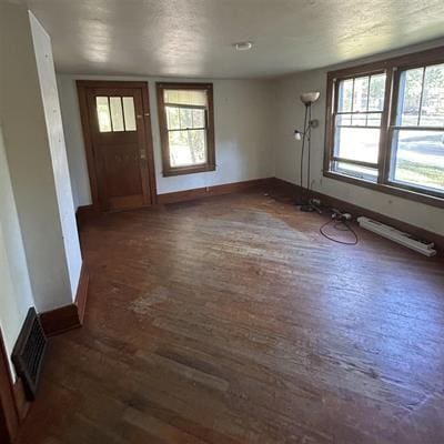 foyer featuring dark hardwood / wood-style floors and a textured ceiling