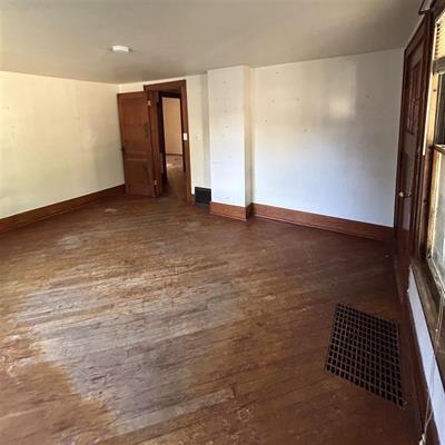 spare room with dark wood-type flooring