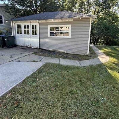 view of outdoor structure with a garage and a yard