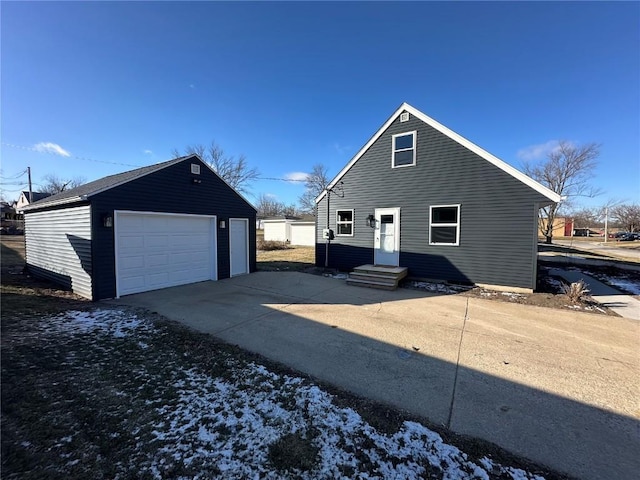 exterior space featuring a garage and an outdoor structure