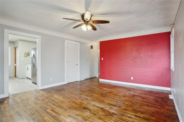 unfurnished room with hardwood / wood-style floors and ceiling fan