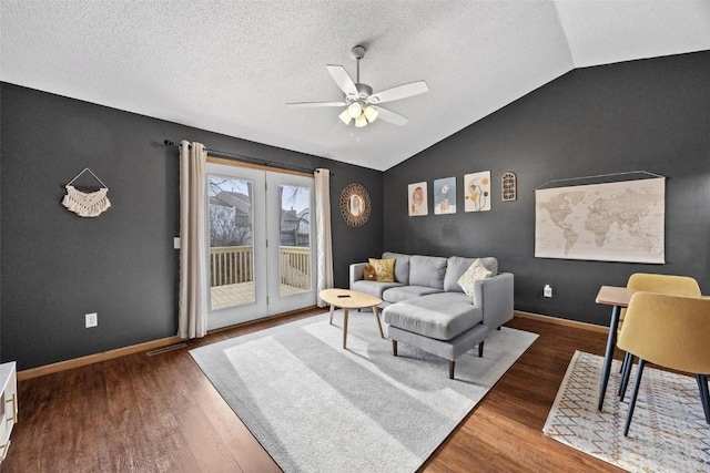 living room featuring a textured ceiling, ceiling fan, lofted ceiling, and dark wood-type flooring