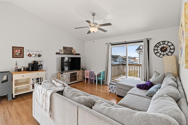 living room featuring lofted ceiling, ceiling fan, and wood-type flooring