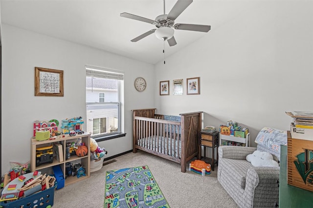 bedroom featuring ceiling fan, light colored carpet, and vaulted ceiling