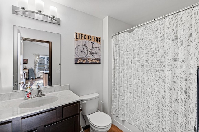 full bathroom featuring shower / bath combo with shower curtain, vanity, and toilet