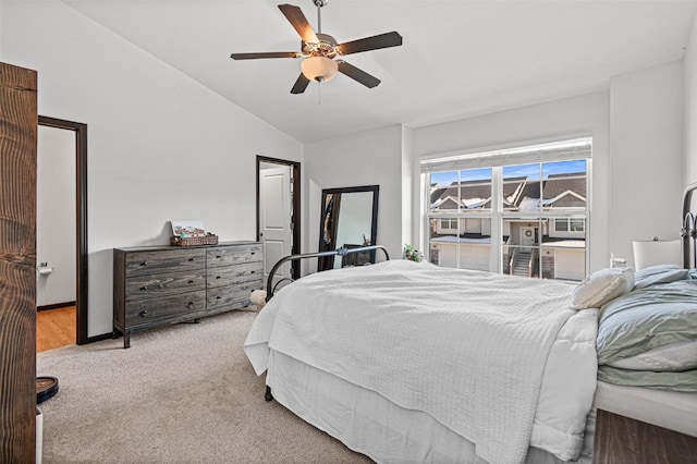 bedroom featuring ceiling fan, light colored carpet, and lofted ceiling