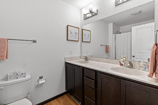 bathroom featuring hardwood / wood-style floors, vanity, and toilet