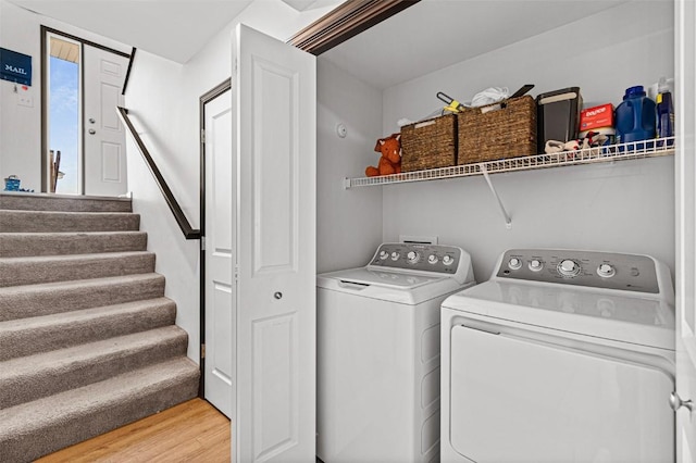 washroom featuring light hardwood / wood-style flooring and washing machine and clothes dryer