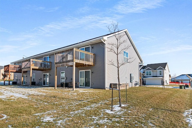 snow covered property featuring a lawn and central air condition unit