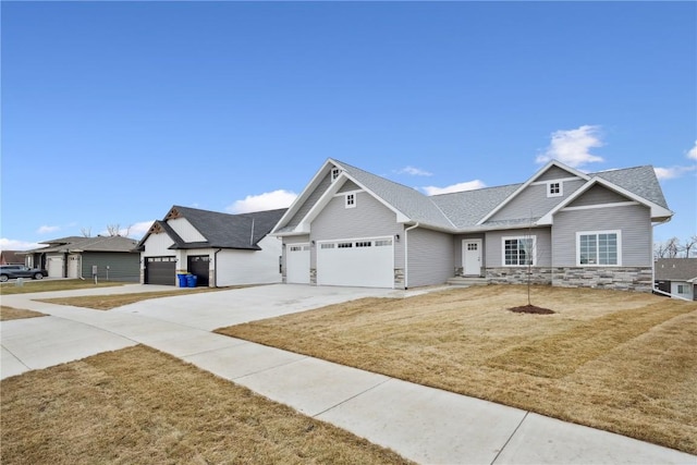 craftsman-style home featuring a front lawn and a garage