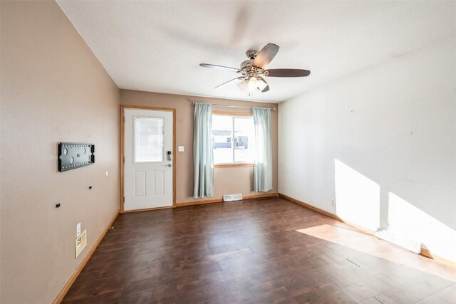 interior space with ceiling fan and dark hardwood / wood-style floors