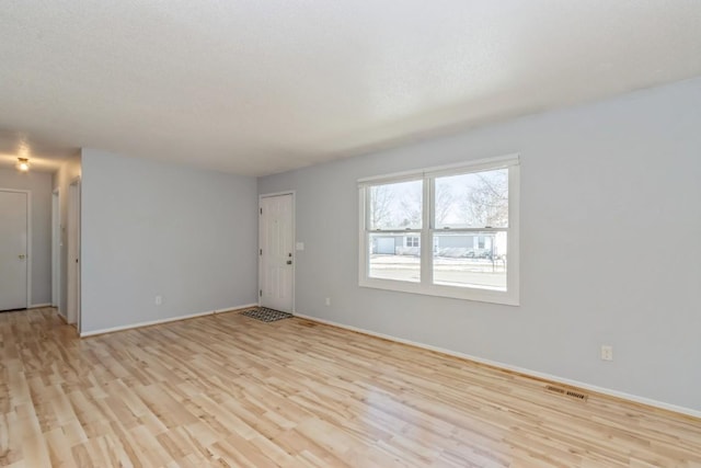 unfurnished room featuring light wood-type flooring