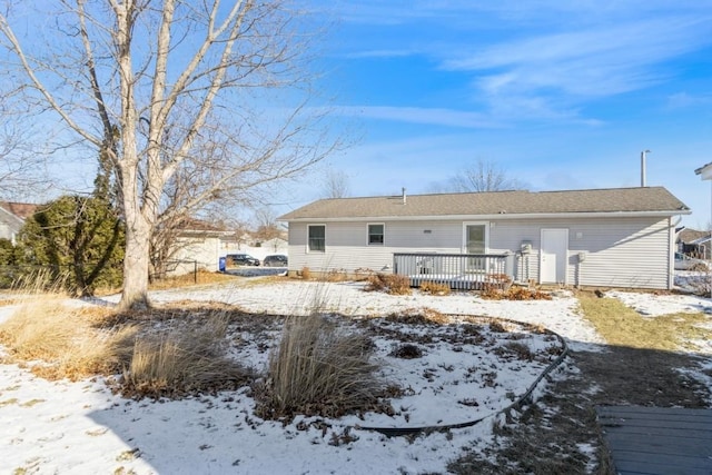 snow covered property featuring a wooden deck