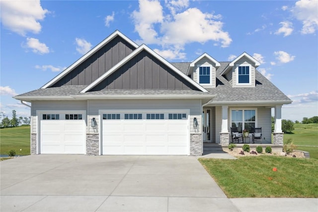 928 Long Dr, Solon, IA 52333 - craftsman-style home with a porch, a garage, and a front yard