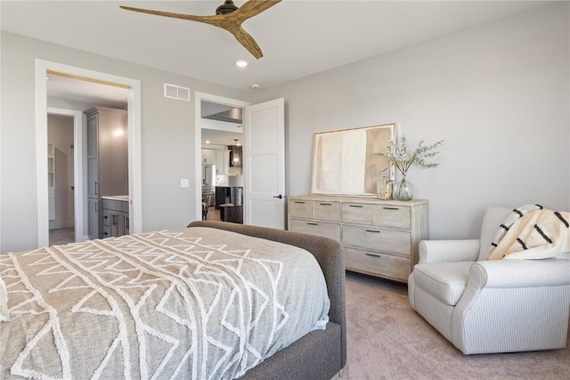 carpeted bedroom featuring ensuite bathroom and ceiling fan