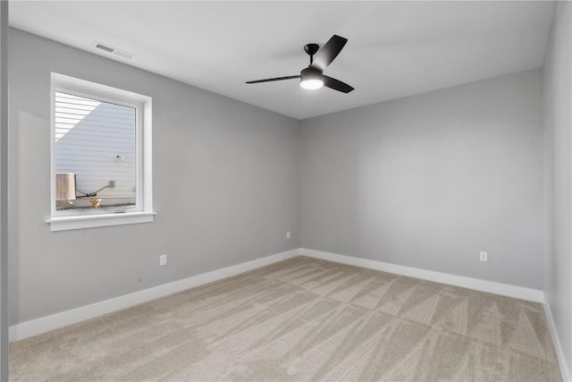 carpeted empty room featuring ceiling fan