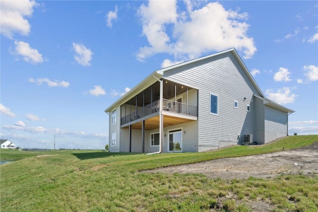 rear view of property with a lawn and central AC