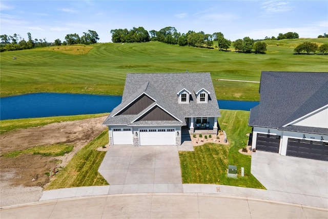 view of front of property with a water view and a garage