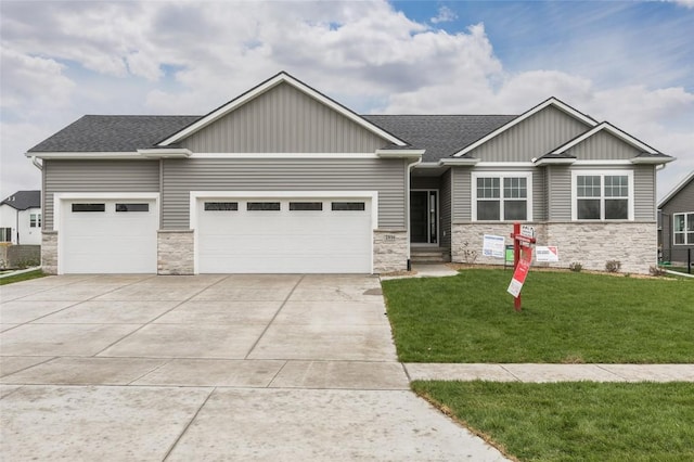 craftsman house with a garage and a front lawn