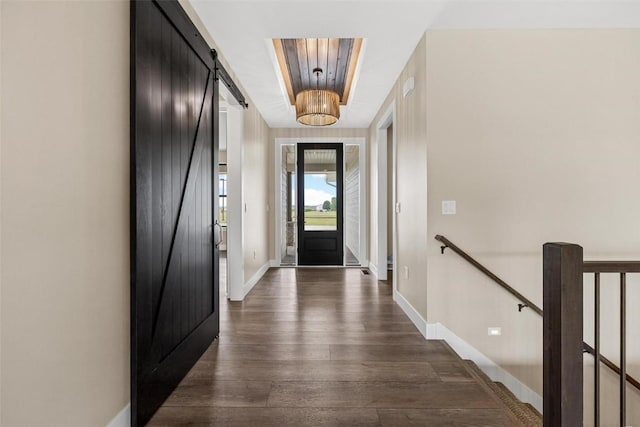 doorway featuring a barn door and dark hardwood / wood-style floors