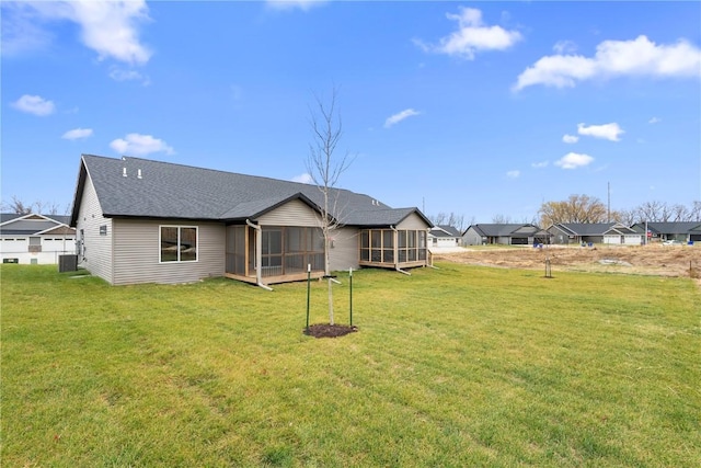 back of house featuring a lawn, central AC, and a sunroom