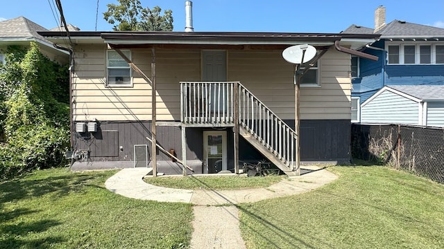 back of house with a lawn