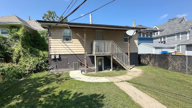 rear view of property with a yard