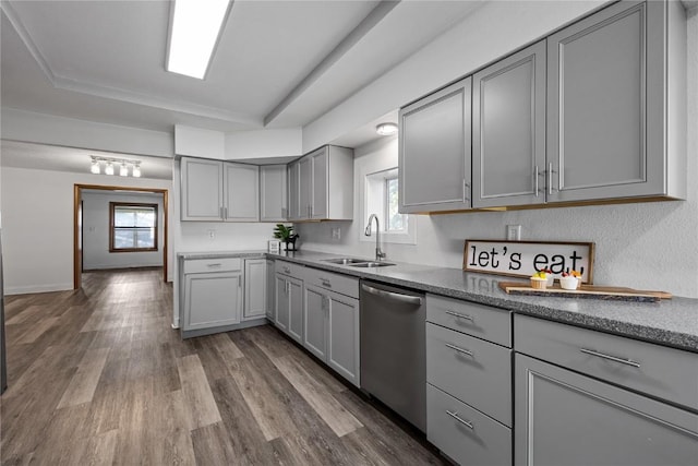 kitchen featuring a wealth of natural light, dishwasher, sink, and gray cabinetry