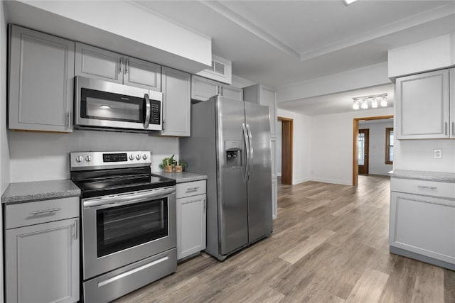 kitchen featuring appliances with stainless steel finishes, gray cabinets, and light hardwood / wood-style floors